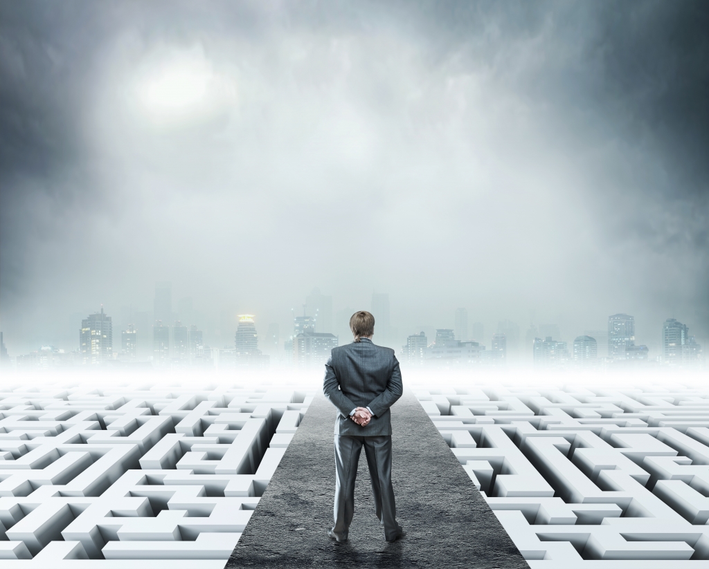 Businessman standing on labyrinth, metaphor for facing difficulties in business and the stress of daily life